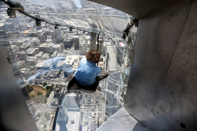 A member of the media rides the Skyslide from the 70th to 69th floor of the U.S. Bank Tower which is attached to the OUE Skyspace LA observation deck in downtown Los Angeles, California, U.S., June 23, 2016. REUTERS/Bob Riha, Jr.