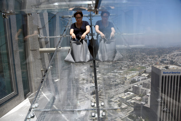 A member of the media rides the Skyslide from the 70th to 69th floor of the U.S. Bank Tower which is attached to the OUE Skyspace LA observation deck in downtown Los Angeles, California, U.S., June 23, 2016. REUTERS/Bob Riha, Jr.