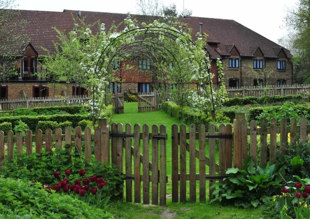 External view of Best Western Plus Grim's Dyke Hotel  with garden arch trellis and wooden gate