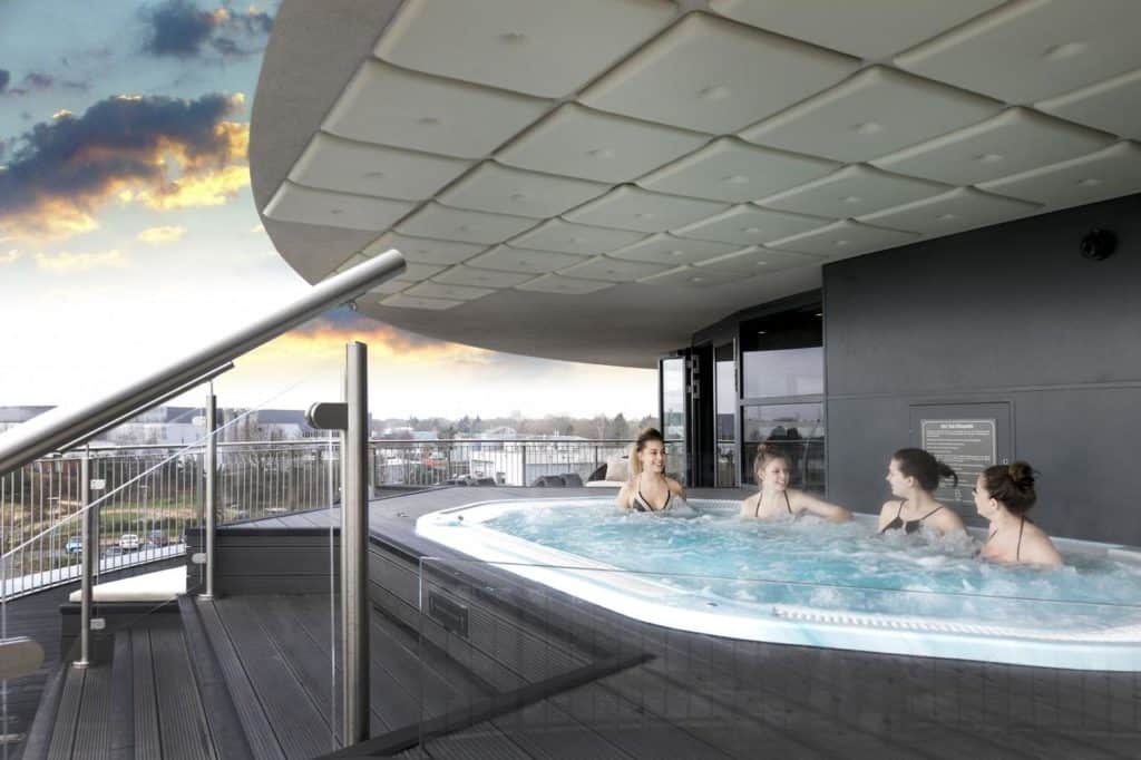 4 women enjoying a hot tube overlooking the city, perfect for families and group of friends at Brooklands Hotel & Spa