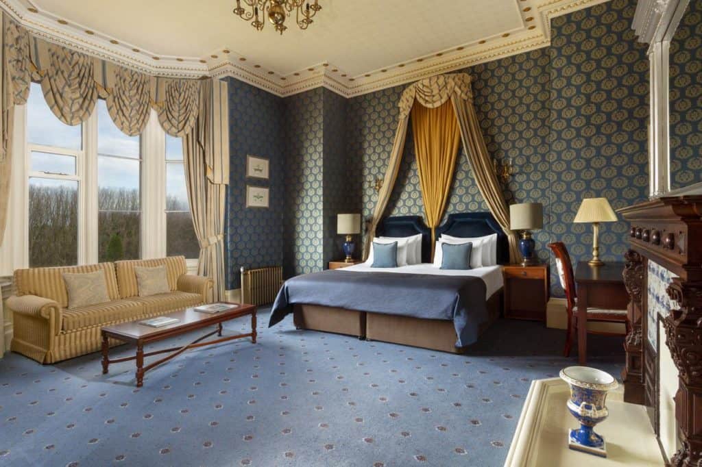 Inside a spacious family-friendly Quad Room with double sofa bed at Crewe Hall 