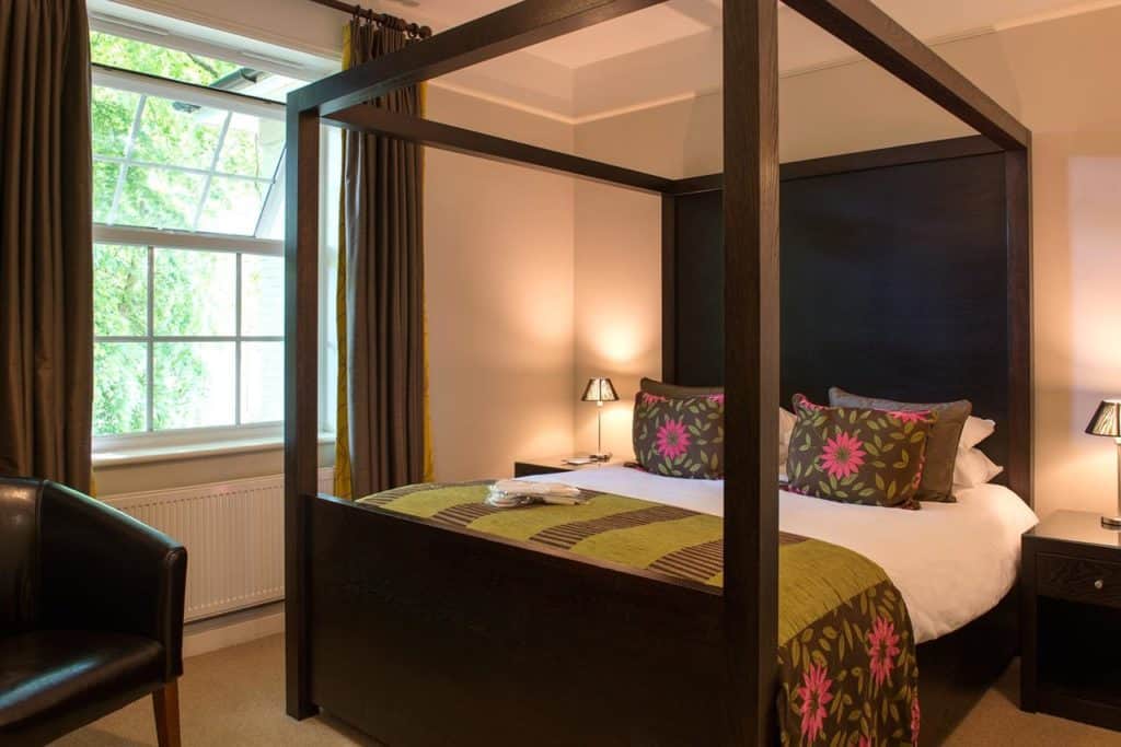 Inside a family-friendly room with four poster double bed at The Forest Lodge Hotel