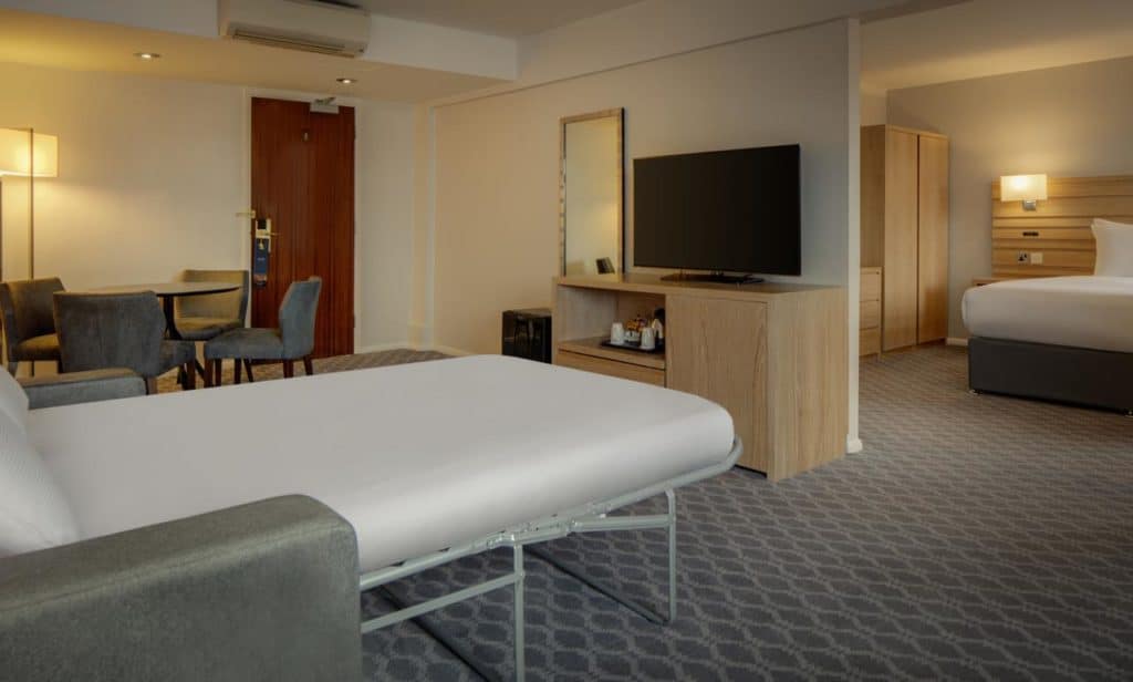 Inside a conjoining room with sofa bed, sleeps 4 at family-friendly Hilton London Watford