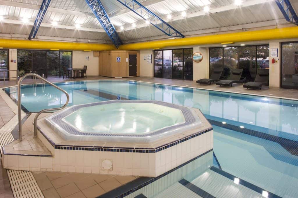 Swimming pool with jacuzzi at family-friendly Holiday Inn Rochester-Chatham near Diggerland