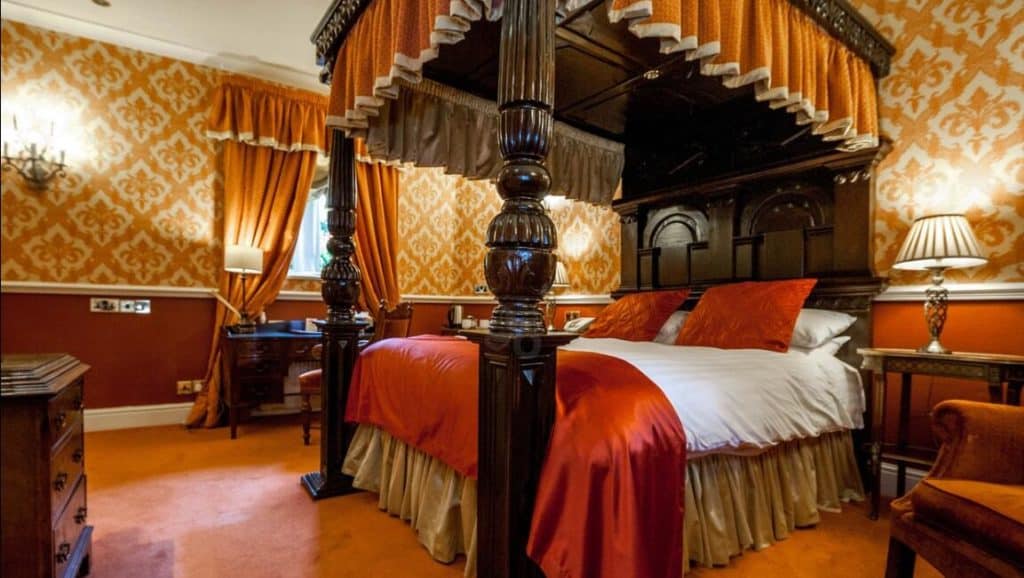 Inside a luxurious room with four-poster bed at kid-friendly Lumley Castle Hotel