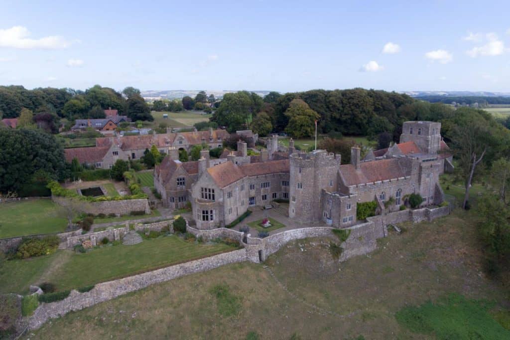 Aerial view of castle-like family-friendly Lympne Castle Cottages near Port Lympne