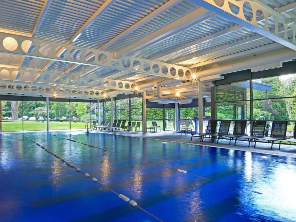 Covered outdoor long swimming pool perfect for family activities at French-chateau styled Macdonald Berystede Hotel & Spa