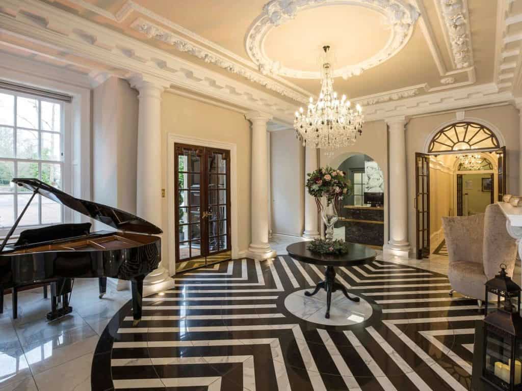 Grand piano and chandeliers make Mercure London North Watford Hunton Park one of the most elegant family-friendly hotel near Harry Potter World