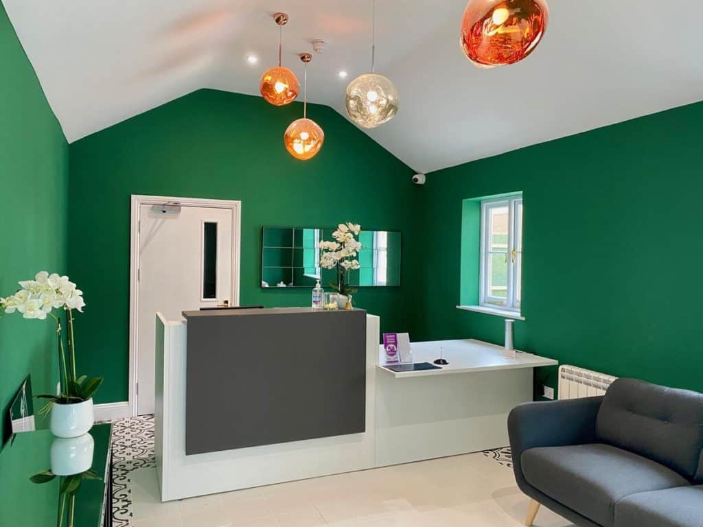 Green-themed living room with quirky lights at kid-friendly Peartree Serviced Apartments