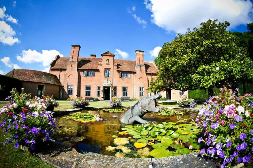 Exterior of kid-friendly Port Lympne Hotel & Reserve with pond and flowers