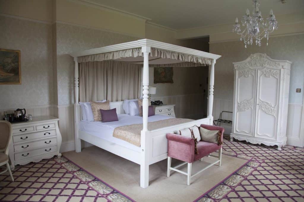 Princess-type four poster bed with elegant chandelier at kid-friendly Shendish Manor Hotel