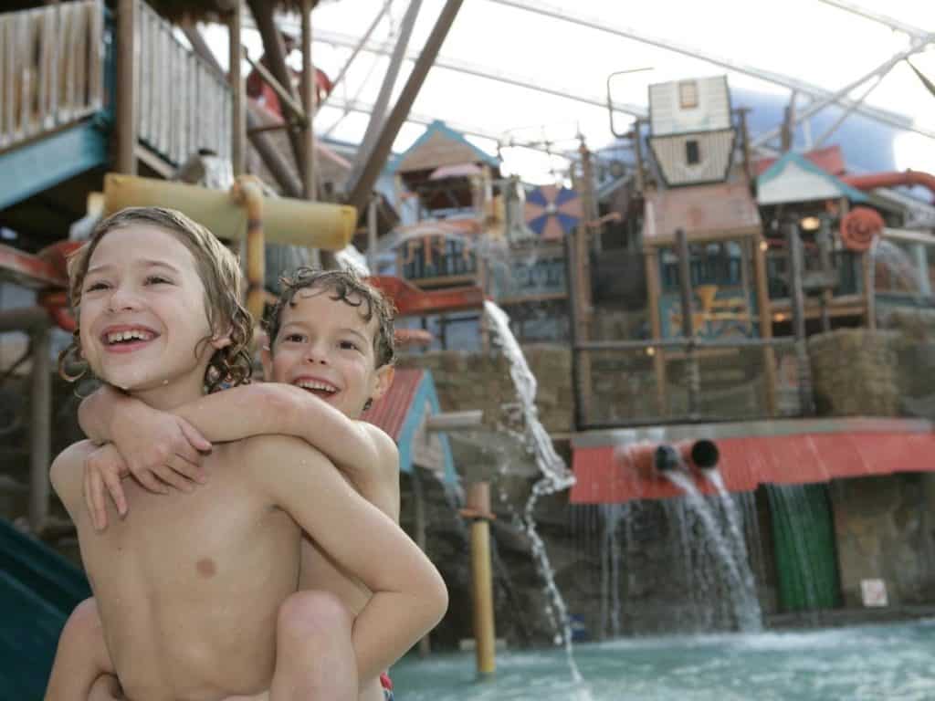 Two kids enjoying the swiming pool at Splash Landings Hotel and waterpark