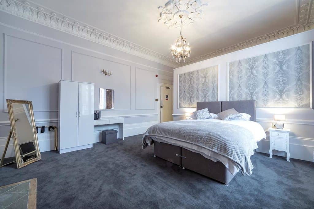 Gray-themed family room with chandelier at The Cuckoo N1