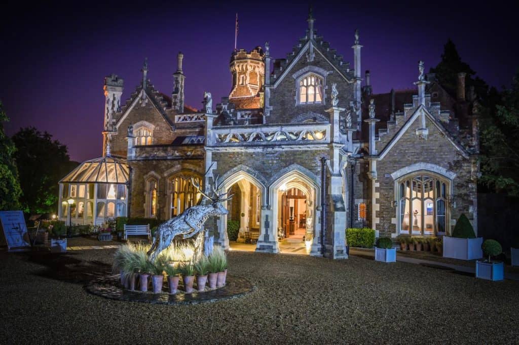 Night time view of reindeer sculpture outside family-friendly luxury hotel, The Oakley Court