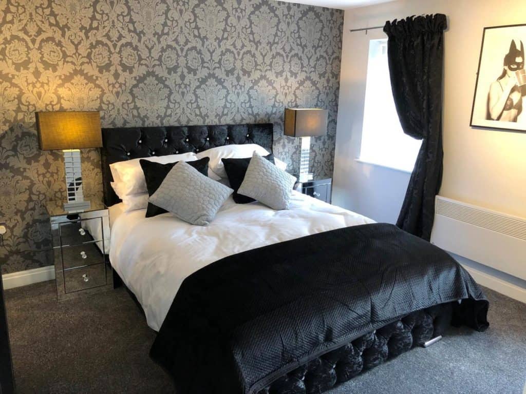 Inside a black and white-themed family room from The Place Blackpool that sleeps 8