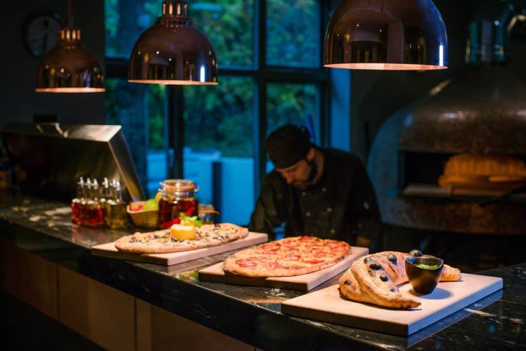 Chef baking the hotel restaurant’s specialty, woodfire pizza at family-friendly The Westmead Hotel