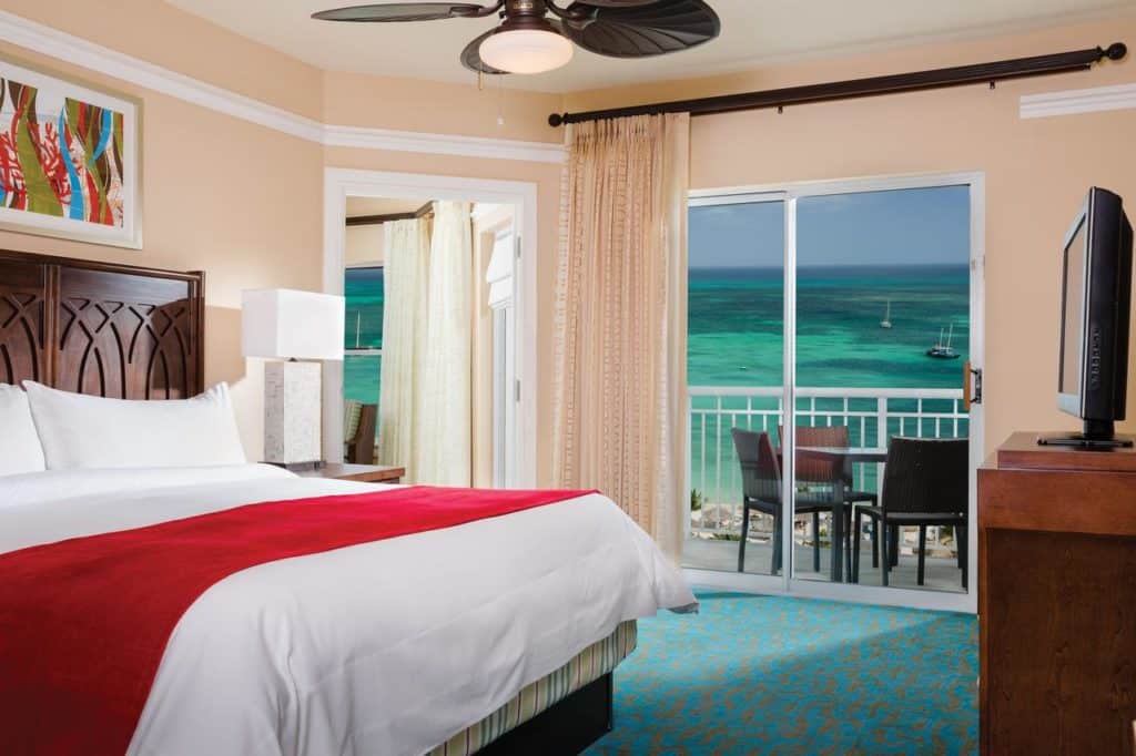 Inside a connecting room for families with a view of the ocean from the balcony at Marriott’s Aruba Surf Club