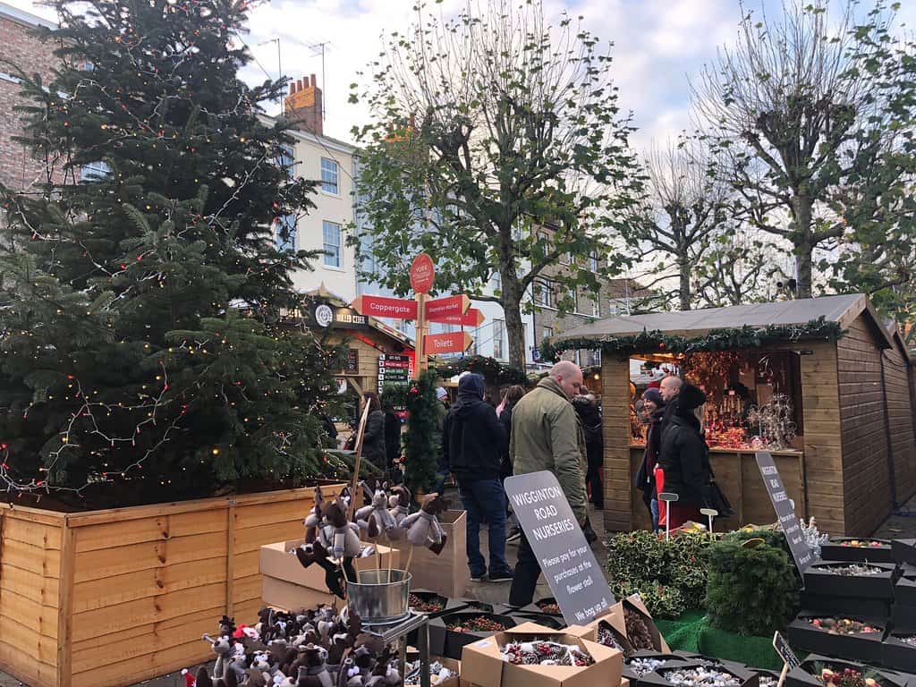 People shopping for trinkets and memorabilia at Shambles Market at York