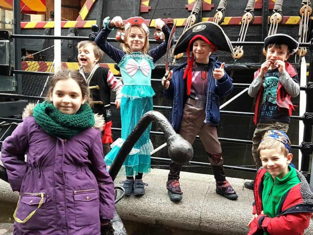 kids having and posing in pirate costumes aboard the golden hinde