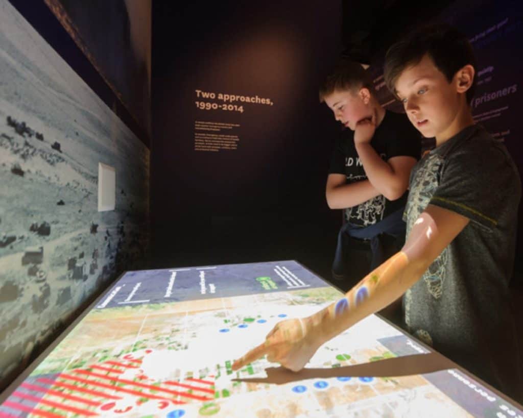 kids playing an interactive battle like real soldiers at the national army museum