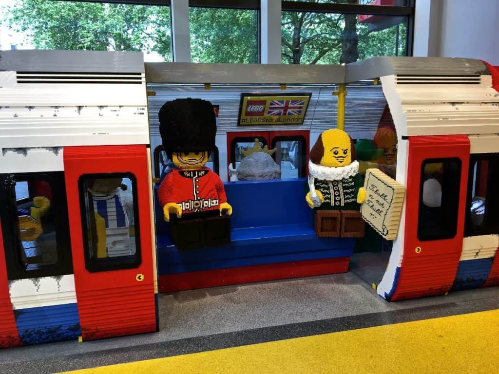 legos that kids can pose and take pictures with at lego store that has life-sized london underground train car