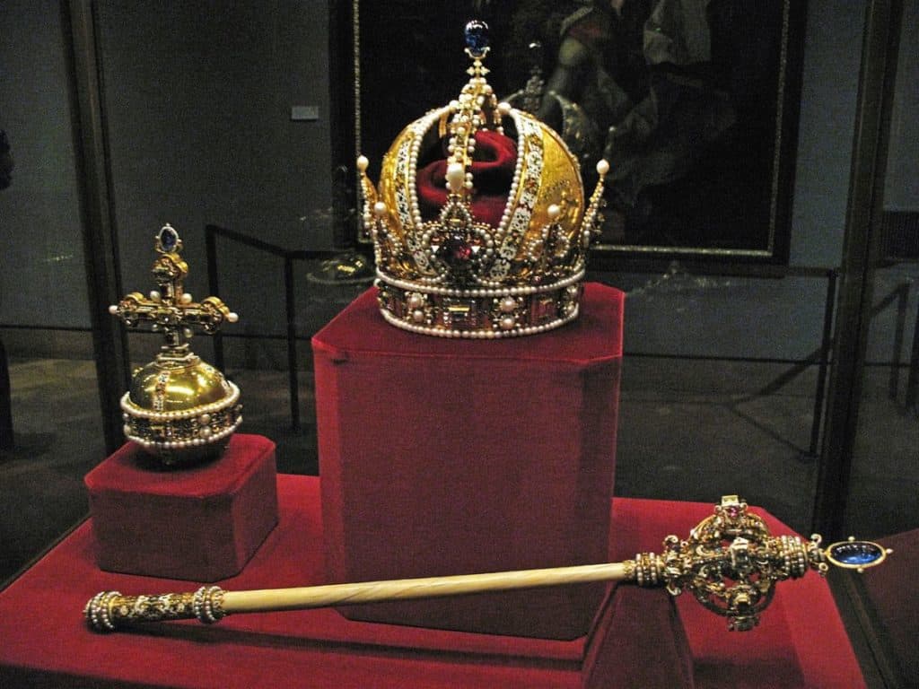 royal crown and ceptre displayed inside the famous tower of london