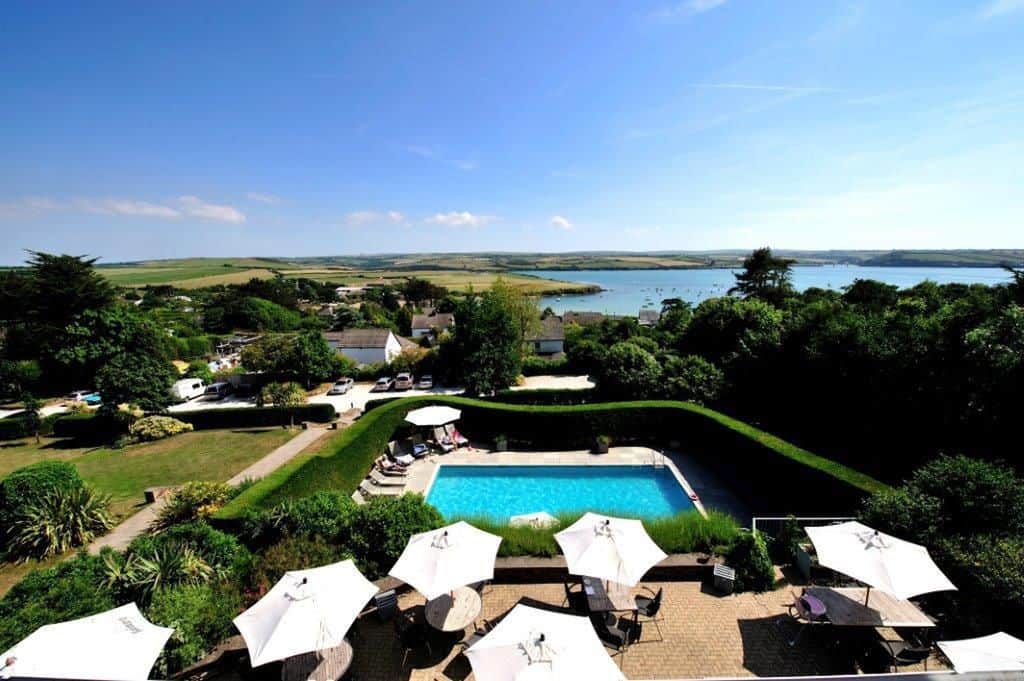 view of the gardens and swimming pool towards the sea in cornwall