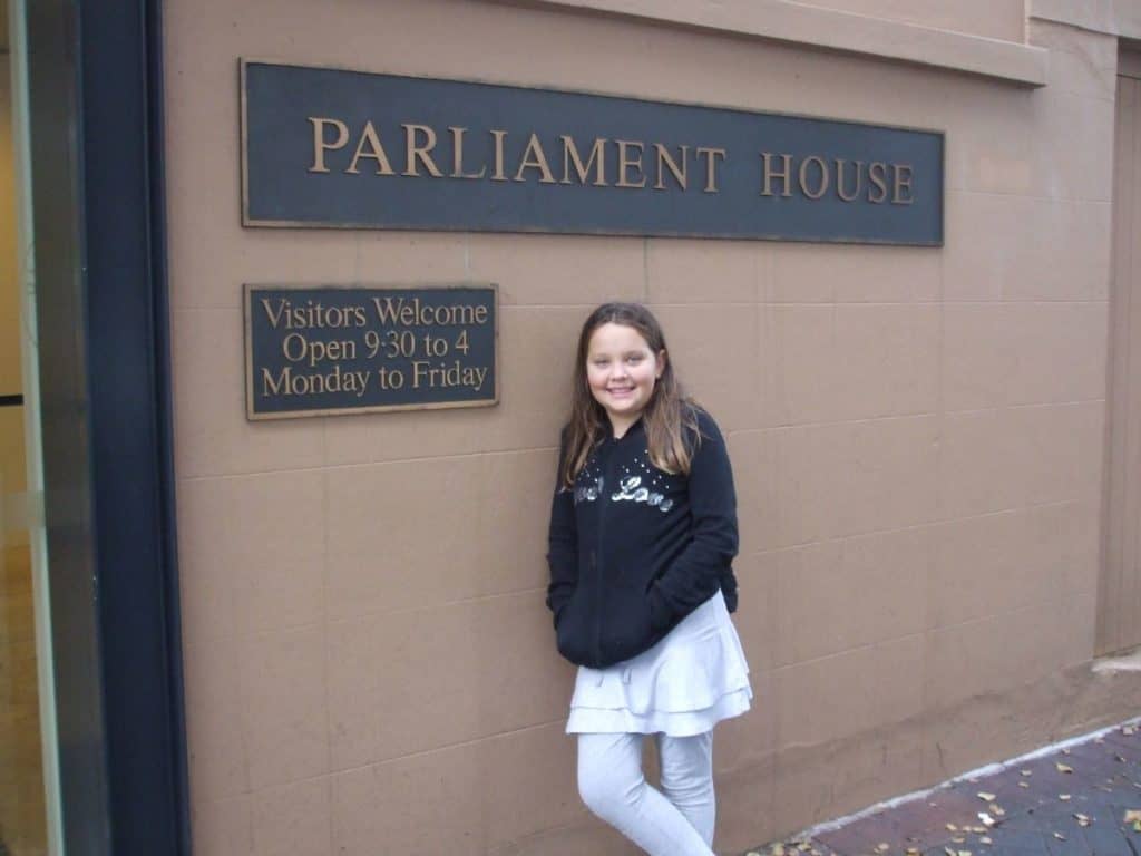 teenager posing outside before going inside to see how the uk government works during question time at the houses of parliament