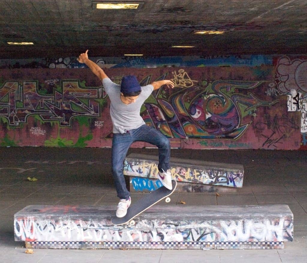 teenager showing off cool skateboarding tricks at the famous south bank skate park