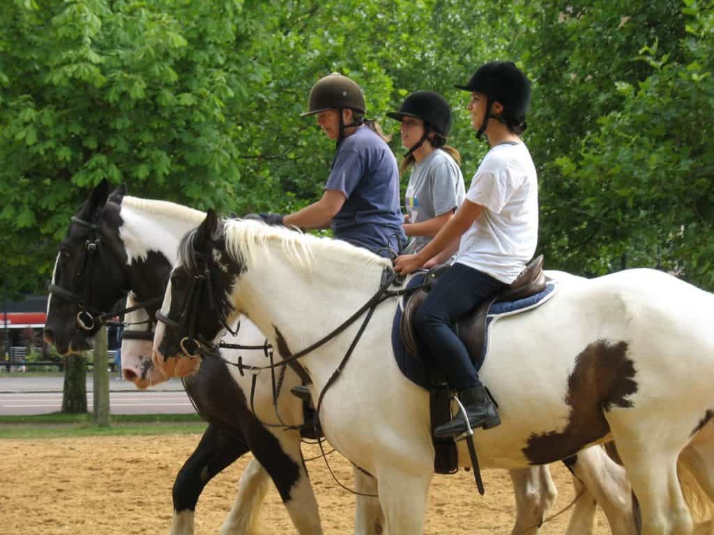 teenagers and kids riding horses like british royalty at hyde park 