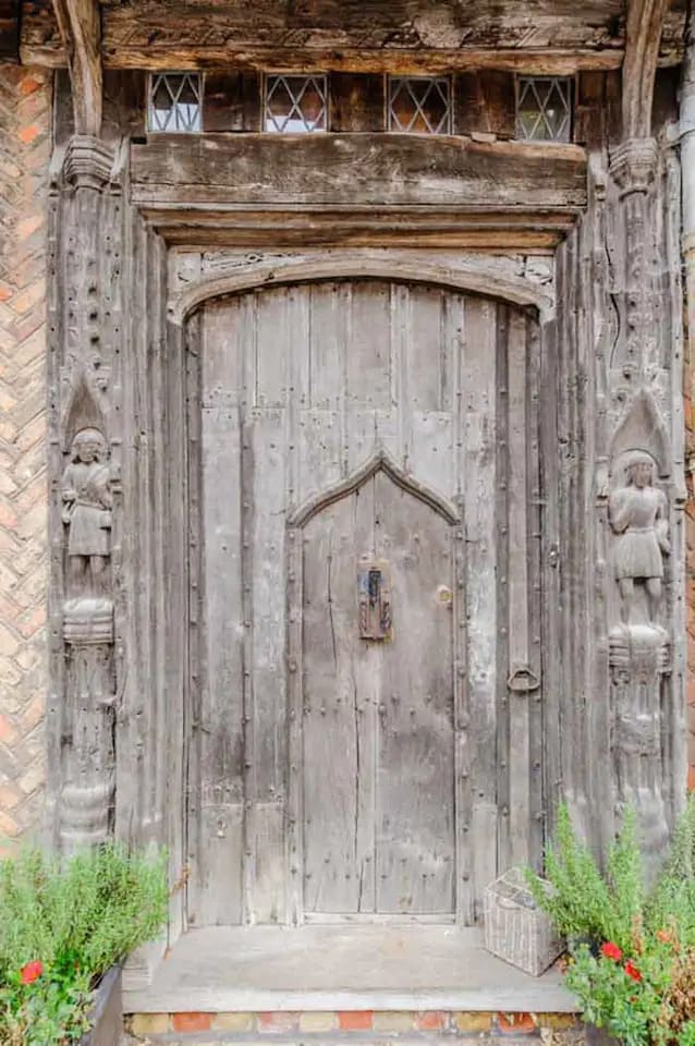 One of the most photographed doors in the world. Our medieval front door with original hand carved huntsmen figures either side.