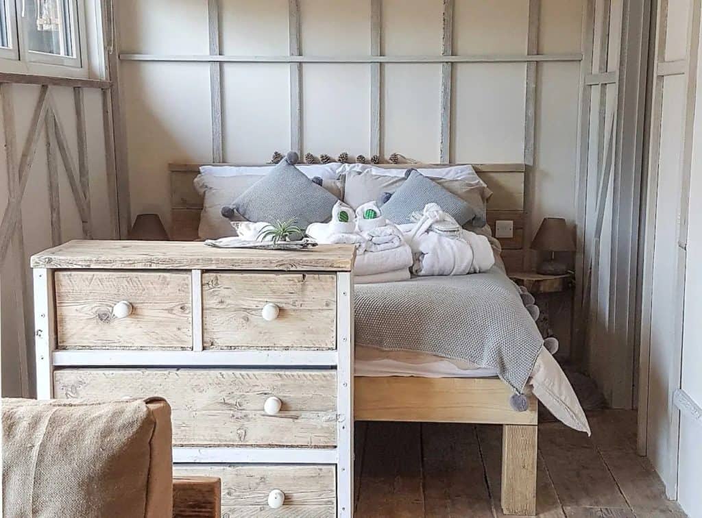 The bedroom area showing hand crafted, originally designed rustic wooden furniture.