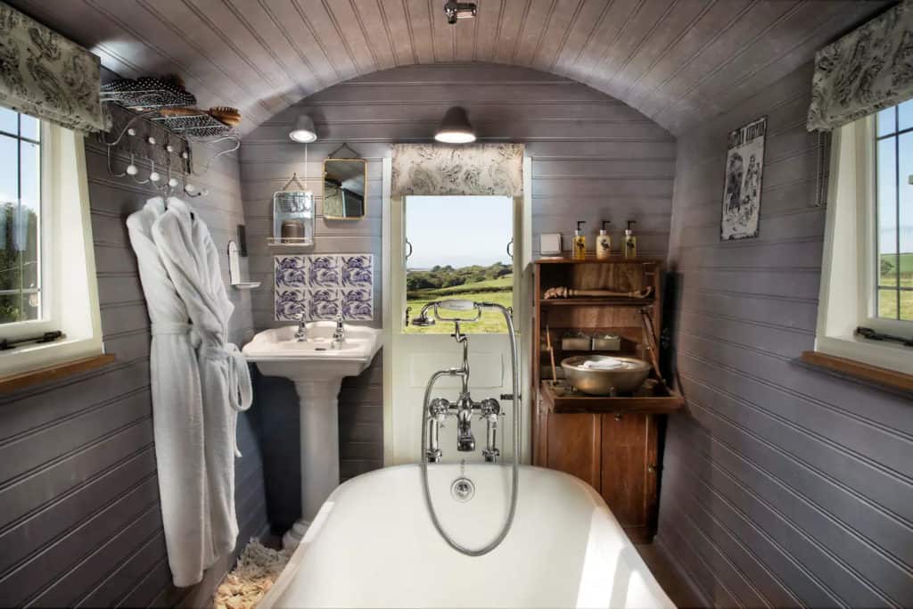 Open the door out to the rolling hills while in the free-standing roll-top bath.